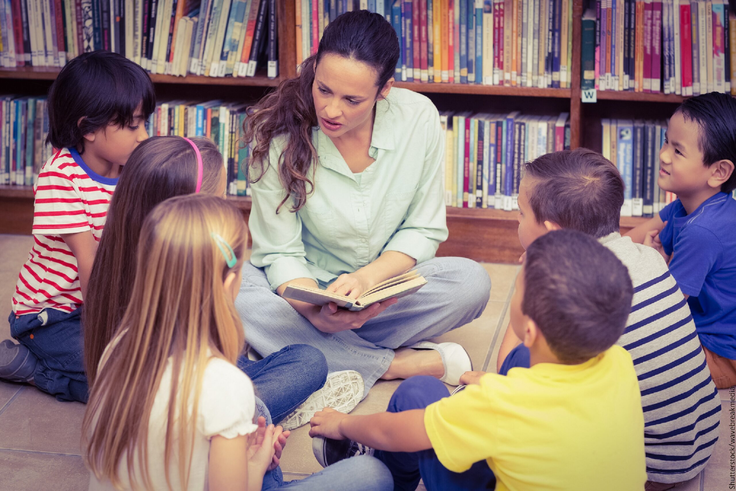 teacher sitting with class